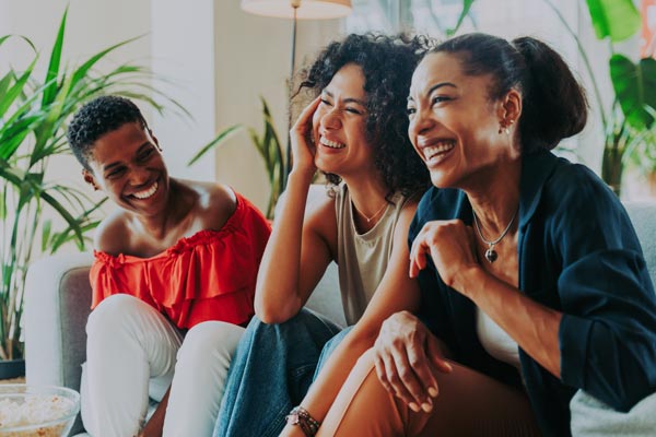 Happy, healthy women laughing on couch